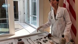 Jennie Jin, a forensic anthropologist who leads the Korea War Project at the Defense POW/MIA Accounting Agency (DPAA), shows some of the objects that accompanied the human remains handed over by North Korea, including a wallet, buttons and canteens, at Joint Base Pearl Harbor-Hickam, Hawaii September 10, 2018. REUTERS/Phil Stewart