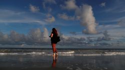 Caitie Sweeney of Myrtle Beach texts her family while visiting the beach ahead of the arrival of Hurricane Florence in Myrtle Beach, South Carolina. REUTERS/Randall Hill