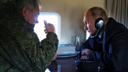 Russian President Vladimir Putin listens to Defence Minister Sergei Shoigu while flying over Tsugol training range in Zabaikalsky region, Russia, September 13, 2018. Sputnik/Alexei Nikolsky/Kremlin via REUTERS