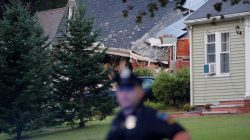 A police officer stands outside a home where a man died in a series of gas explosions in Lawrence, Massachusetts, U.S., September 14, 2018. REUTERS/Brian Snyder