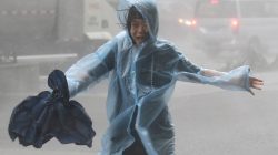 A woman runs in the rainstorm as Typhoon Mangkhut approaches, in Shenzhen, China September 16, 2018. REUTERS/Jason Lee