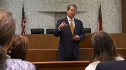 FILE PHOTO: Georgia Secretary of State Brian Kemp speaks with visitors to the state capitol about the "SEC primary" involving a group of southern states voting next month in Atlanta, Georgia February 24, 2016. REUTERS/Letitia Stein/File Photo