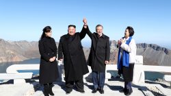 South Korean President Moon Jae-in and North Korean leader Kim Jong Un pose for photographs on the top of Mt. Paektu, North Korea September 20, 2018. Pyeongyang Press Corps/Pool via REUTERS