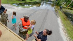 U.S. Army Pfc. Marlen Squire, of the South Carolina National Guard, assists in evacuating local residents from floodwaters as a result of Hurricane Florence in Dongola, South Carolina, U.S. September 24, 2018. Staff Sgt. Jorge Intriago/U.S. Army National Guard/Handout via REUTERS