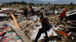 Policemen walk at the ruins of a church after an earthquake hit Jono Oge village in Sigi, Indonesia's Sulawesi island, October 3, 2018. REUTERS/Beawiharta