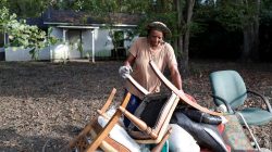 Katrina Bullock, who is still in the process of rebuilding after floods from Hurricane Matthew in 2016, stacks debris in front of her home after flooding due to Hurricane Florence receded in Fair Bluff, North Carolina, U.S. September 29, 2018. REUTERS/Randall Hill