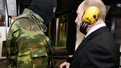 FILE PHOTO: Russian President Vladimir Putin and a masked security officer stand at a shooting gallery of the new GRU military intelligence headquarters building as he visits it in Moscow, Russia November 8, 2006.REUTERS/ITAR-TASS/PRESIDENTIAL PRESS SERVICE/File Photo