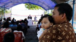 People attend an outdoor church service in the earthquake damaged area of Jono oge village, in Sigi district, south of Palu, Central Sulawesi, Indonesia October 7, 2018. REUTERS/Darren Whiteside