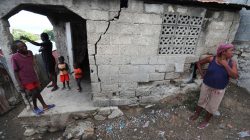 People stand outside their home after it was damaged in an earthquake, that hit northern Haiti late on Saturday, in Port-de-Paix, Haiti, October 8, 2018. REUTERS/Ricardo Rojas