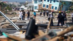 First responders and residents walk along a main street following Hurricane Michael in Mexico Beach, Florida, U.S., October 11, 2018. REUTERS/Carlo Allegri