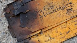 FILE PHOTO: A burnt Columbia Gas of Massachusetts envelope sits on the sidewalk outside a home burned during a series of gas explosions in Lawrence, Massachusetts, U.S., September 14, 2018. REUTERS/Brian Snyder/File Photo