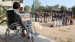 Muhammad al-Shadheli, 9, who survived an August 2018 Saudi-led air strike on a school bus, sits on a wheelchair during the morning drill at his school in Saada province, Yemen October 6, 2018. REUTERS/Naif Rahma