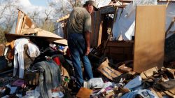 Bernard Sutton, 64, picks through the remains of his home destroyed by Hurricane Michael in Fountain, Florida, U.S., October 15, 2018. REUTERS/Terray Sylvester