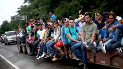 Honduran migrants, part of a caravan trying to reach the U.S., are pictured on a truck during a new leg of their travel in Zacapa, Guatemala October 17, 2018. REUTERS/Edgard Garrido