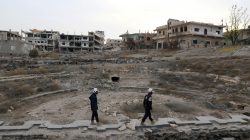 FILE PHOTO: Members of the Civil Defence, also known as the 'White Helmets', are seen inspecting the damage at a Roman ruin site in Daraa, Syria December 23, 2017. REUTERS/Alaa al-Faqir/File Photo