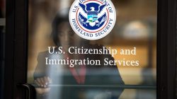 A woman leaves the U.S. Citizenship and Immigration Services offices in New York, August 15, 2012. REUTERS/Keith Bedford