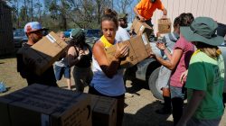 50 Star Search and Rescue team members and volunteers unload a pallet of MREs (Meal, Ready-to-Eat) at a relief center at Fountain's Victory Tabernacle church in Fountain, Florida, U.S., October 18, 2018. REUTERS/Brian Snyder