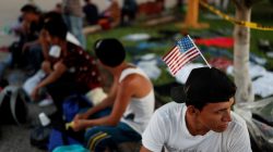 Jose Garcia, a migrant from Honduras en route to the United States, rests in a public square as he waits to regroup with more migrants, in Tecun Uman, Guatemala October 25, 2018. REUTERS/Carlos Garcia Rawlins