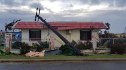 A downed power line sits on a damaged building after Super Typhoon Yutu hit Saipan, Northern Mariana Islands, U.S., October 25, 2018 in this image taken from social media. Brad Ruszala via REUTE