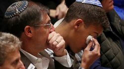 FILE PHOTO: Mourners react during a memorial service at the Sailors and Soldiers Memorial Hall of the University of Pittsburgh, a day after 11 worshippers were shot dead at a Jewish synagogue in Pittsburgh, Pennsylvania, U.S., October 28, 2018. REUTERS/Cathal McNaughton