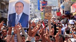 FILE PHOTO: Protesters hold up a poster of Yemeni President Abd-Rabbu Mansour Hadi during a protest against the deteriorating economy in Taiz, Yemen, October 4, 2018. REUTERS/Anees Mahyoub/File Photo