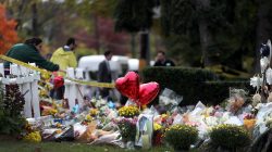 FILE PHOTO: People pray at a makeshift memorial near the Tree of Life synagogue following Saturday's shooting at the synagogue in Pittsburgh, Pennsylvania, U.S., October 31, 2018. REUTERS/Cathal McNaughton