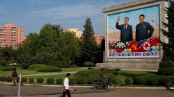 FILE PHOTO: Residents pass by a painting of late North Korean leaders Kim Il Sung and Kim Jong Il in Pyongyang, North Korea, September 6, 2018. REUTERS/Danish Siddiqui