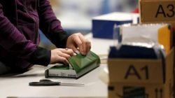 FILE PHOTO - A worker gift wraps a holiday order for a customer at the Amazon Fulfillment Center in Tracy, California, November 29, 2015. REUTERS/Fred Greaves