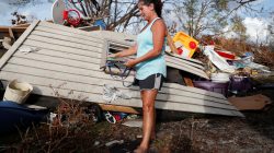 Denise Bass, 56, looks through her belongings in the aftermath of Hurricane Michael at her home in Lynn Haven, Florida, U.S., November 5, 2018. REUTERS/Terray Sylvester