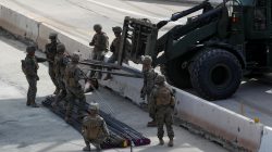 U.S. Marines work to move building materials as they harden the border with Mexico in preparation for the arrival of a caravan of migrants at the San Ysidro border crossing in San Diego, California, U.S., November 13, 2018. REUTERS/Mike Blake